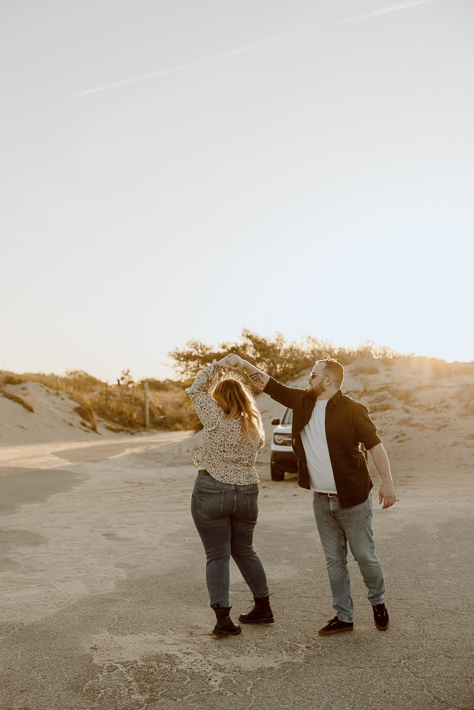 Couple spins in circles during sunset.