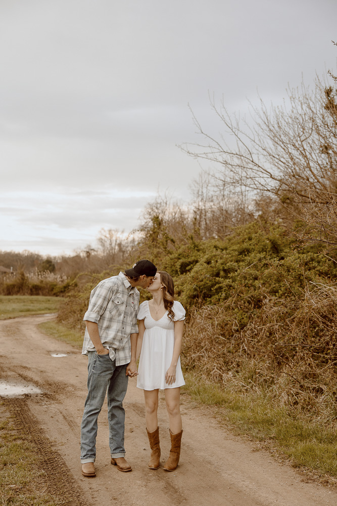 Couple shares a kiss while walking.