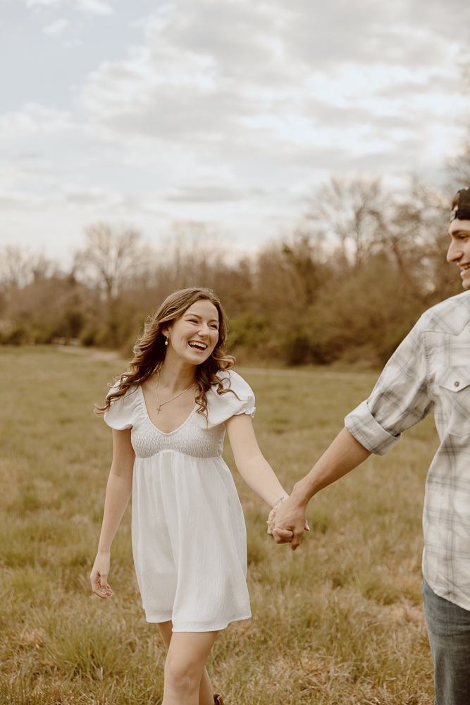 Couple smiles to each other during engagement photos.