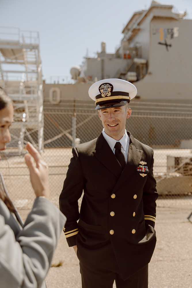 A navy sailor smiling at his wife after reuniting.