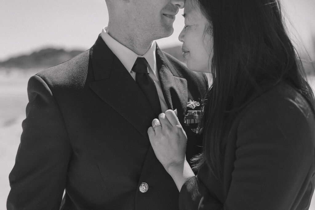 A navy spouse holds her husband close in a hug after reuniting. 