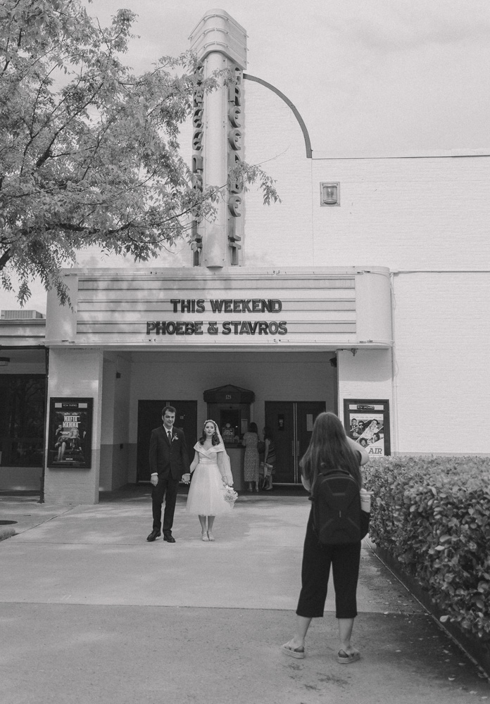 Wedding photographer taking a photo of a wedding couple.