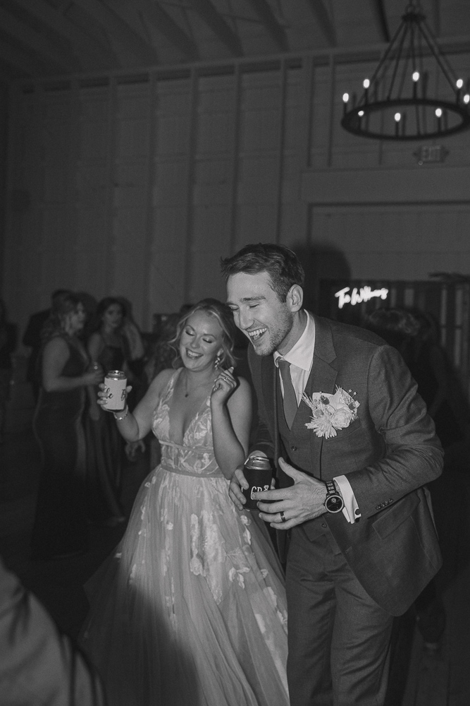 Groom smiles and dances at his reception