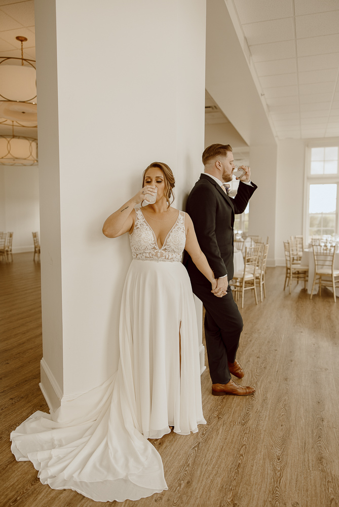 Bride and Groom take a shot of alcohol during their first touch on their wedding day.