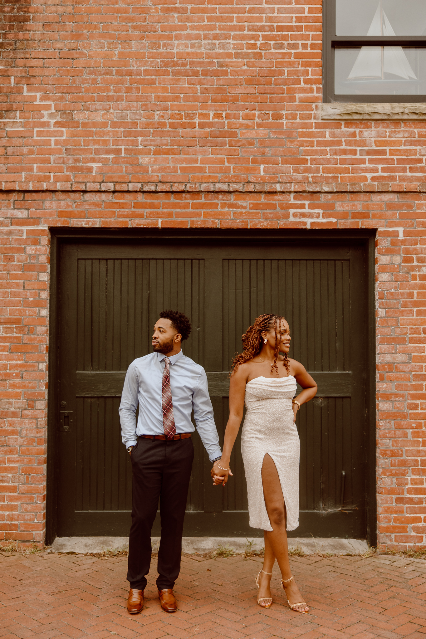 couple holding hands and looking in opposite directions